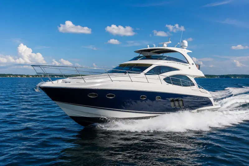Blue and white motor yacht cruising on open water